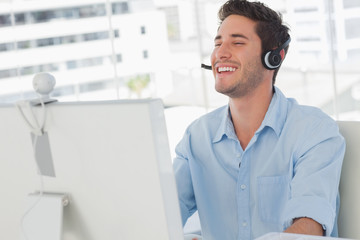 Happy designer laughing during an online communication