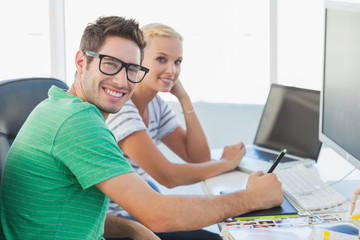 Obraz premium Attractive photo editors working together on graphics tablet