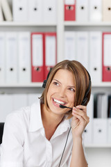 Laughing businesswoman talking on headset