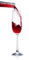 Red wine poured in a glass isolated on white