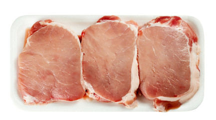 Pack of raw pork meat in a plate on white