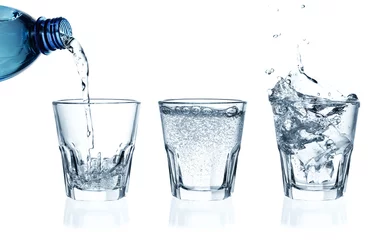 Foto auf Acrylglas Pouring water on a glass. Ice splashing into glass of water © aleksandra_1981