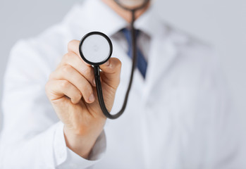 doctor hand with stethoscope listening something