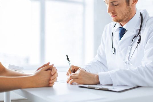 Patient And Doctor Taking Notes