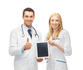 Fototapeta premium young doctors holding tablet pc in hands