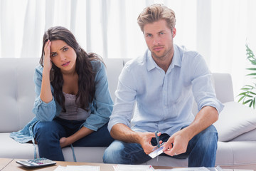 Couple looking anxious while doing their accounts