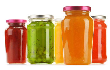 Jars of fruity jams isolated on white background