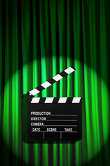 Movie clapper board against curtain