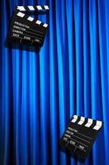 Movie clapper board against curtain