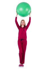 Young woman with ball exercising on white