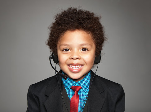 Smiling cute child with headphones and microphone