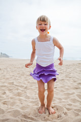 Young girl playing on beach