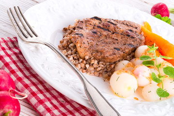 grill chop, buckwheat groats and roasted radishes