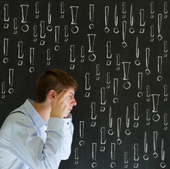 Thinking business man with chalk exclamation marks