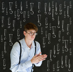 Thinking business man with chalk exclamation marks