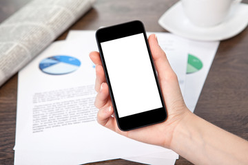 woman hand holding a phone on the table with graphics