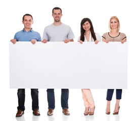 Group Of Friends Holding Placard