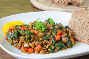 Stewed lentils with spinach, pepper and onion