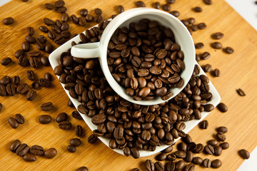 beans of  coffee and cup on the plate