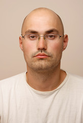 Portrait. Bald man with glasses.