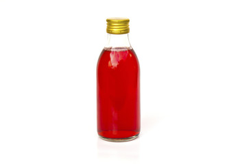 Close up on a medicine bottle with red syrup isolated on a white