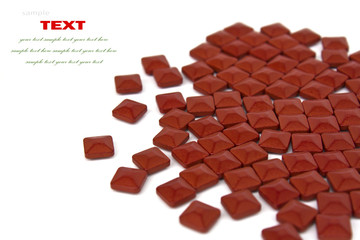 Red square medicinal pills on a white background with space for