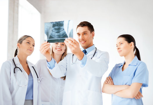 young group of doctors looking at x-ray