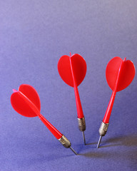 Darts on purple background