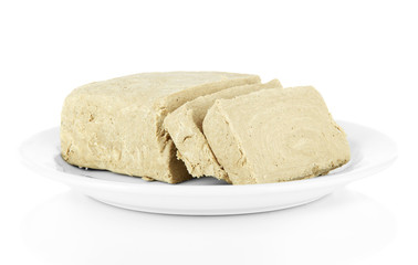 Tasty halva on plate isolated on white