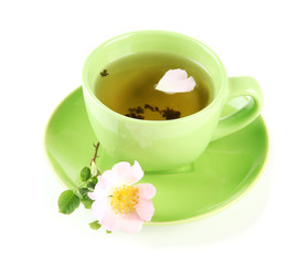 Cup of herbal tea with hip rose flower, isolated on white