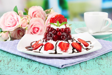 Tasty jelly dessert with fresh berries, on bright background
