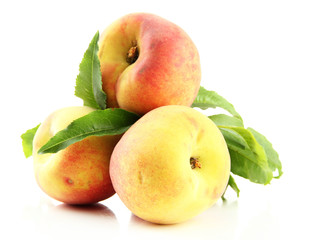 Ripe sweet peaches with leaves, isolated on white
