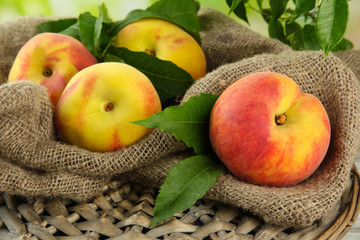 Ripe sweet peaches on wooden table in garden, close up
