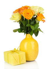 Beautiful bouquet of roses in vase with gift isolated on white