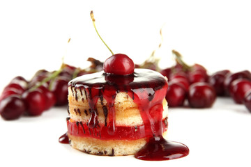 Tasty biscuit cake with jam and berries isolated on white