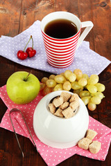 Unrefined sugar in white sugar bowl on wooden background