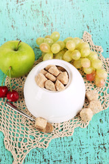 Unrefined sugar in white sugar bowl on wooden background