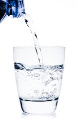 filling a glass with water trough blue bottle