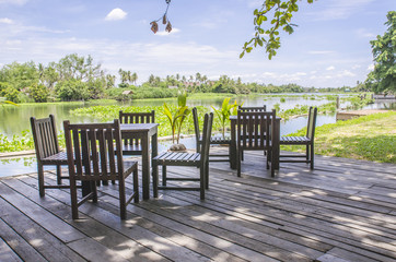 Wooden table and chair at the river front with beautyful view
