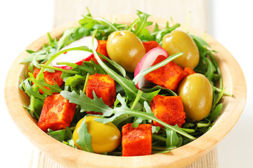 Salad greens with olives and spicy cheese