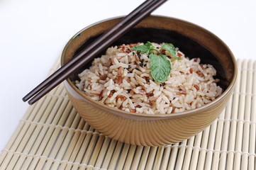 Raw mixed rice in ceramic bowl on white backgroud