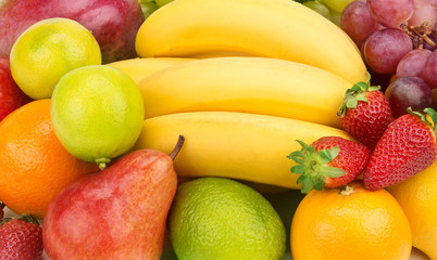Fototapeta na wymiar Multicolored background of fruits and berries