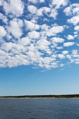 Obraz premium White clouds over Baltic sea.