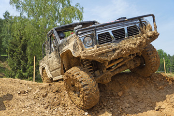 SUV overcomes steep muddy slope. © frank11