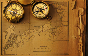 Antique compass over old map
