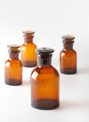 Small chemical glass bottles on white background