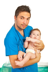 Pediatrician holding baby