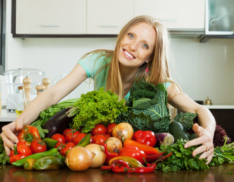 happy woman with pile of vegetables