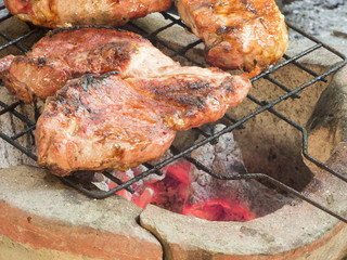 Pork steak on the grill, low heat stove.
