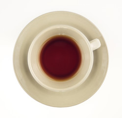 Black tea in cup isolated on white overhead shot